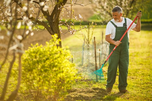 Operative wearing PPE conducting a dynamic risk assessment in a garden